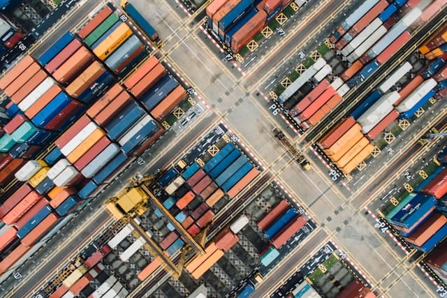 Aerial view of a busy shipping container terminal.